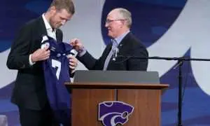 Kansas State new head football coach Collin Klein holds a jersey given by athletic director Gene Taylor during his introduction ceremony at Morgan Family Arena on Dec. 5, 2025.