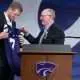 Kansas State new head football coach Collin Klein holds a jersey given by athletic director Gene Taylor during his introduction ceremony at Morgan Family Arena on Dec. 5, 2025.