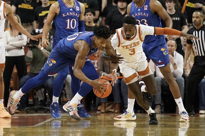 Feb 7, 2022; Austin, Texas, USA; Kansas Jayhawks guard Ochai Agbaji (30) and Texas Longhorns guard Courtney Ramey (3) battle for the loose ball during the first half at Frank C. Erwin Jr. Center. Mandatory Credit: Scott Wachter-USA TODAY Sports