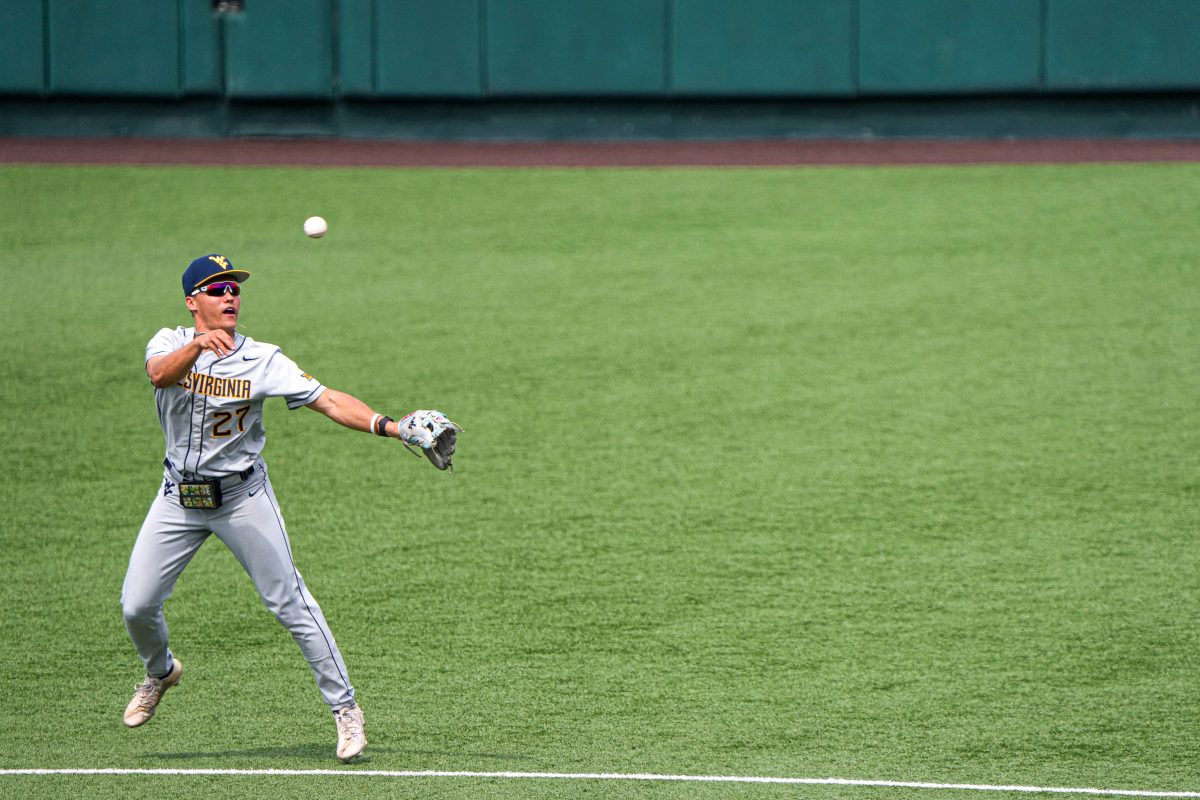 West Virginia infielder JJ Wetherholt (27) throws the ball to first during the game against the Texas Longhorns at UFCU Disch-Falk Field on Saturday, May 20, 2023 in Austin.