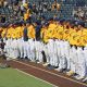 West Virginia Baseball team locks arms before the first pitch.
