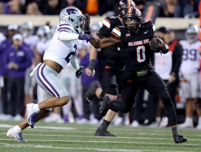Oklahoma State's Ollie Gordon II (0) tries to get by Kansas State's Kobe Savage (2) in the first half of the college football game between the Oklahoma State University Cowboys and the Kansas State Wildcats at Boone Pickens Stadium in Stillwater. Okla., Friday, Oct. 6, 2023. OSU won 29-21.