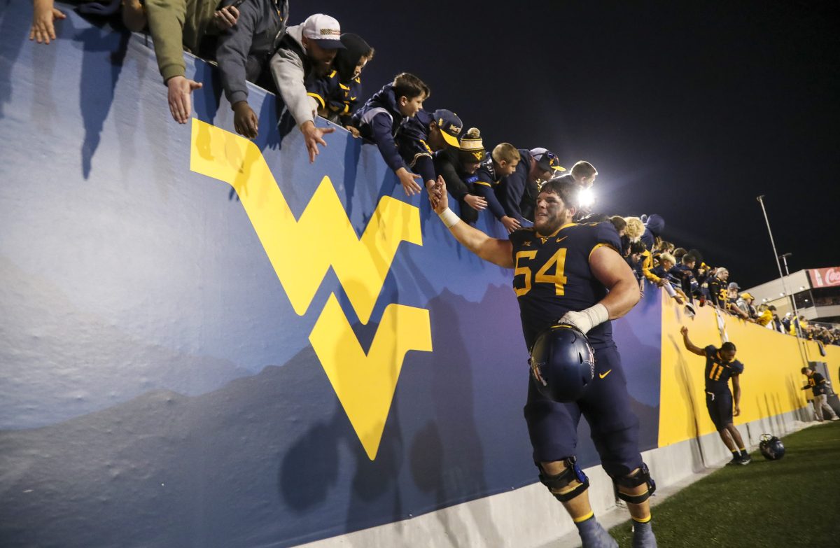 Nov 4, 2023; Morgantown, West Virginia, USA; West Virginia Mountaineers offensive lineman Zach Frazier (54) celebrates with fans after defeating the Brigham Young Cougars at Mountaineer Field at Milan Puskar Stadium. Mandatory Credit: Ben Queen-USA TODAY Sports
