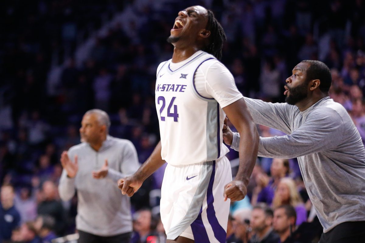 Kansas State junior transfer wing Arthur Kaluma (24) yells out after graduate transfer guard Tylor Perry (2) scores over Oral Roberts in overtime of Tuesday's game inside Bramlage Coliseum.