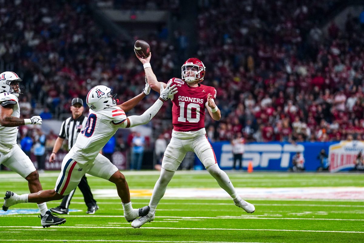 Dec 28, 2023; San Antonio, TX, USA; Oklahoma Sooners quarterback Jackson Arnold (10) avoids Arizona Wildcats defensive lineman Isaiah Ward (90) to throw for a touchdown in the first half at Alamodome. Mandatory Credit: Daniel Dunn-USA TODAY Sports