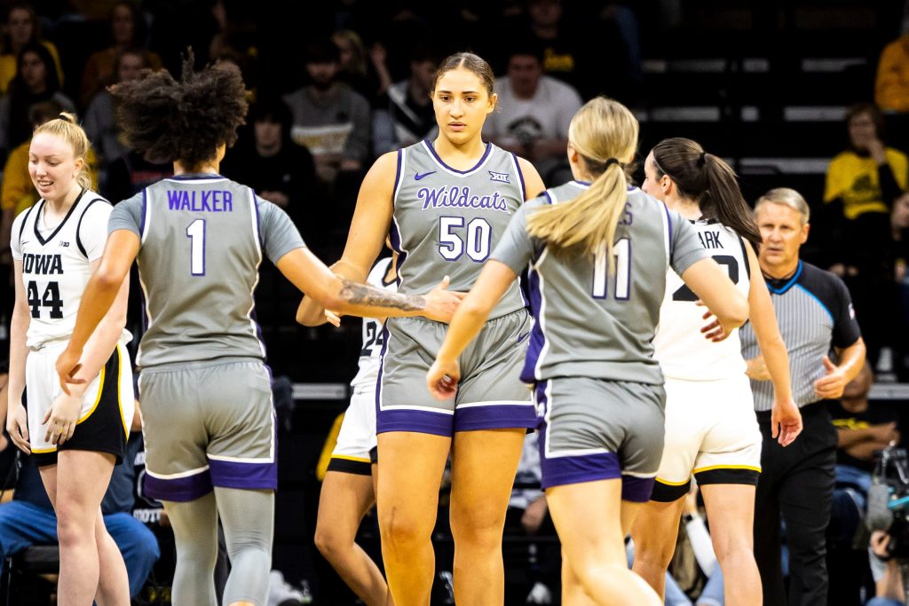 Kansas State center Ayoka Lee (50) is greeted by teammates Zyanna Walker, left, and Taryn Sides during NCAA women's basketball game against Iowa, Thursday, Nov. 16, 2023, at Carver-Hawkeye Arena in Iowa City, Iowa.