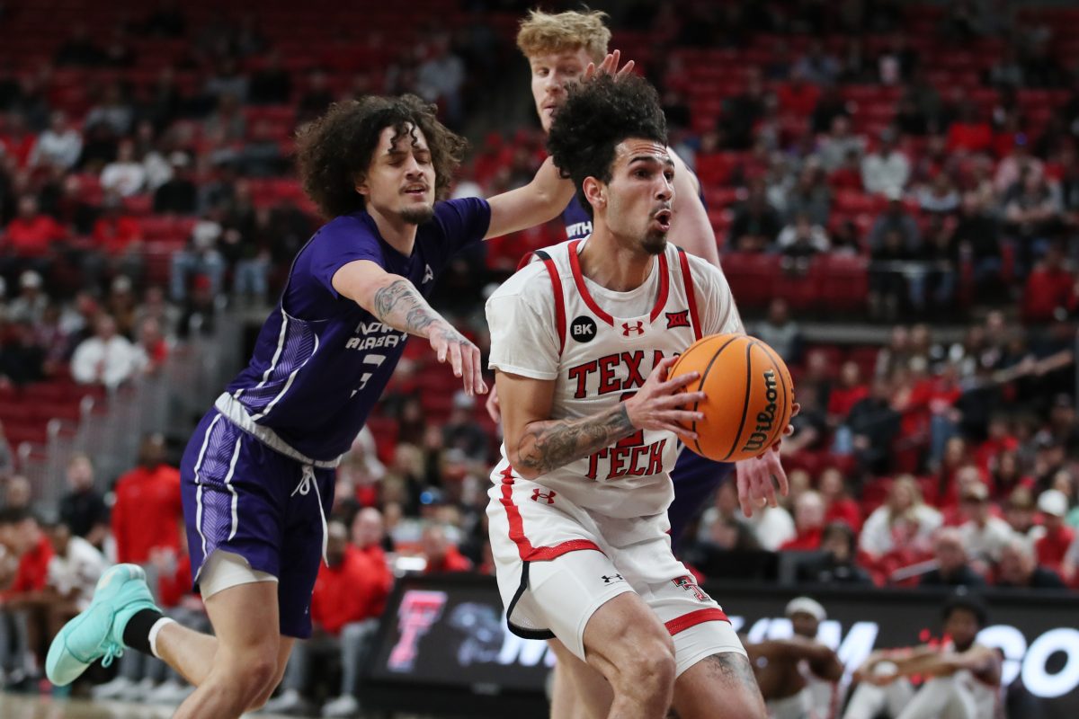 Jan 1, 2024; Lubbock, Texas, USA; Texas Tech Red Raiders guard Pop Isaacs (2) stops to take a shot against North Alabama Lions guard KJ Johnson (3) in the first half at United Supermarkets Arena. Mandatory Credit: Michael C. Johnson-USA TODAY Sports