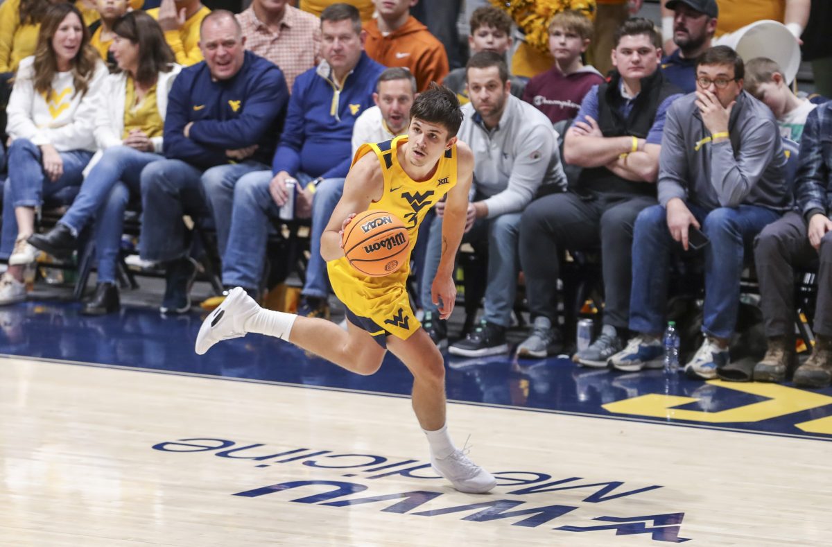 Jan 13, 2024; Morgantown, West Virginia, USA; West Virginia Mountaineers guard Kerr Kriisa (3) dribbles up the floor during the second half against the Texas Longhorns at WVU Coliseum. Mandatory Credit: Ben Queen-USA TODAY Sports