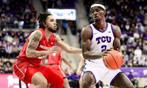Jan 13, 2024; Fort Worth, Texas, USA; TCU Horned Frogs forward Emanuel Miller (2) controls the ball as Houston Cougars guard Emanuel Sharp (21) defends during the first half at Ed and Rae Schollmaier Arena. Mandatory Credit: Kevin Jairaj-USA TODAY Sports