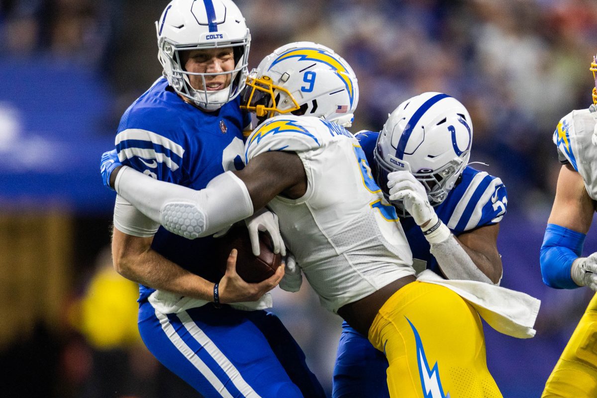 Dec 26, 2022; Indianapolis, Indiana, USA; Los Angeles Chargers linebacker Kenneth Murray Jr. (9) sacks Indianapolis Colts quarterback Nick Foles (9) in the first half at Lucas Oil Stadium. Mandatory Credit: Trevor Ruszkowski-USA TODAY Sports