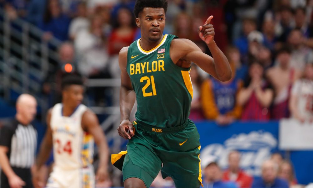 Baylor freshman center Yves Missi (21) points back after scoring against Kansas in the first half of the game Saturday, February 10, 2024 inside Allen Fieldhouse.