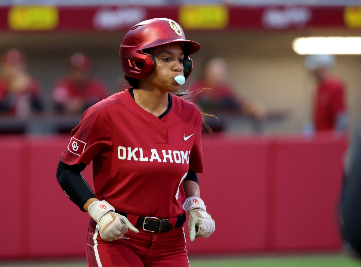 Oklahoma's Rylie Boone (0) runs to first base after a walk during the college softball game between the University of Oklahoma Sooners and Texas A&M Commerce at Love's Field in Norman, Okla., Wednesday, March 6, 2024.
