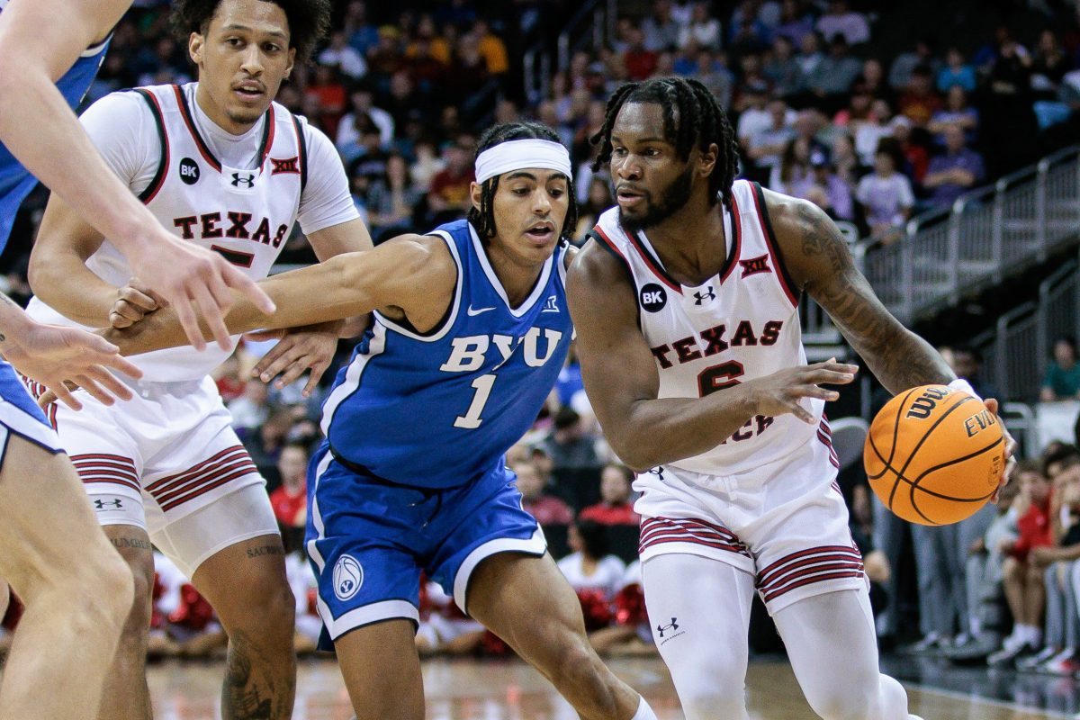 Mar 14, 2024; Kansas City, MO, USA; Texas Tech Red Raiders guard Joe Toussaint (6) drives to the basket around Brigham Young Cougars guard Trey Stewart (1) during the first half at T-Mobile Center. Mandatory Credit: William Purnell-USA TODAY Sports