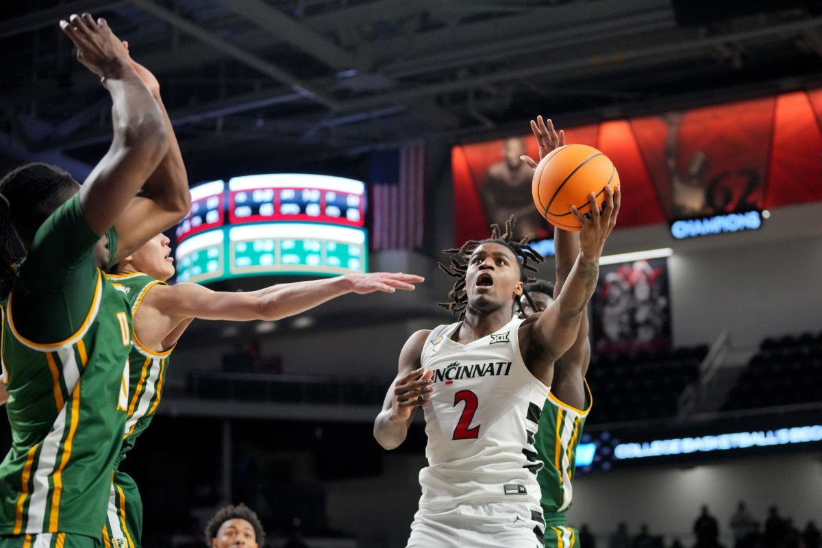 Cincinnati Bearcats guard Jizzle James (2) rises to the basket in the first half of a college basketball game against the San Francisco Dons in the National Invitation Tournament, Wednesday, March 20, 2024, at Fifth Third Arena in Cincinnati.