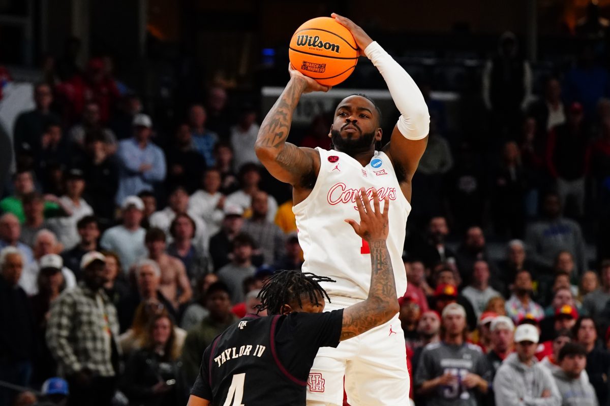 Mar 24, 2024; Memphis, TN, USA; Houston Cougars guard Jamal Shead (1) shoots against Texas A&M Aggies guard Wade Taylor IV (4) in overtime in the second round of the 2024 NCAA Tournament at FedExForum. Mandatory Credit: John David Mercer-USA TODAY Sports