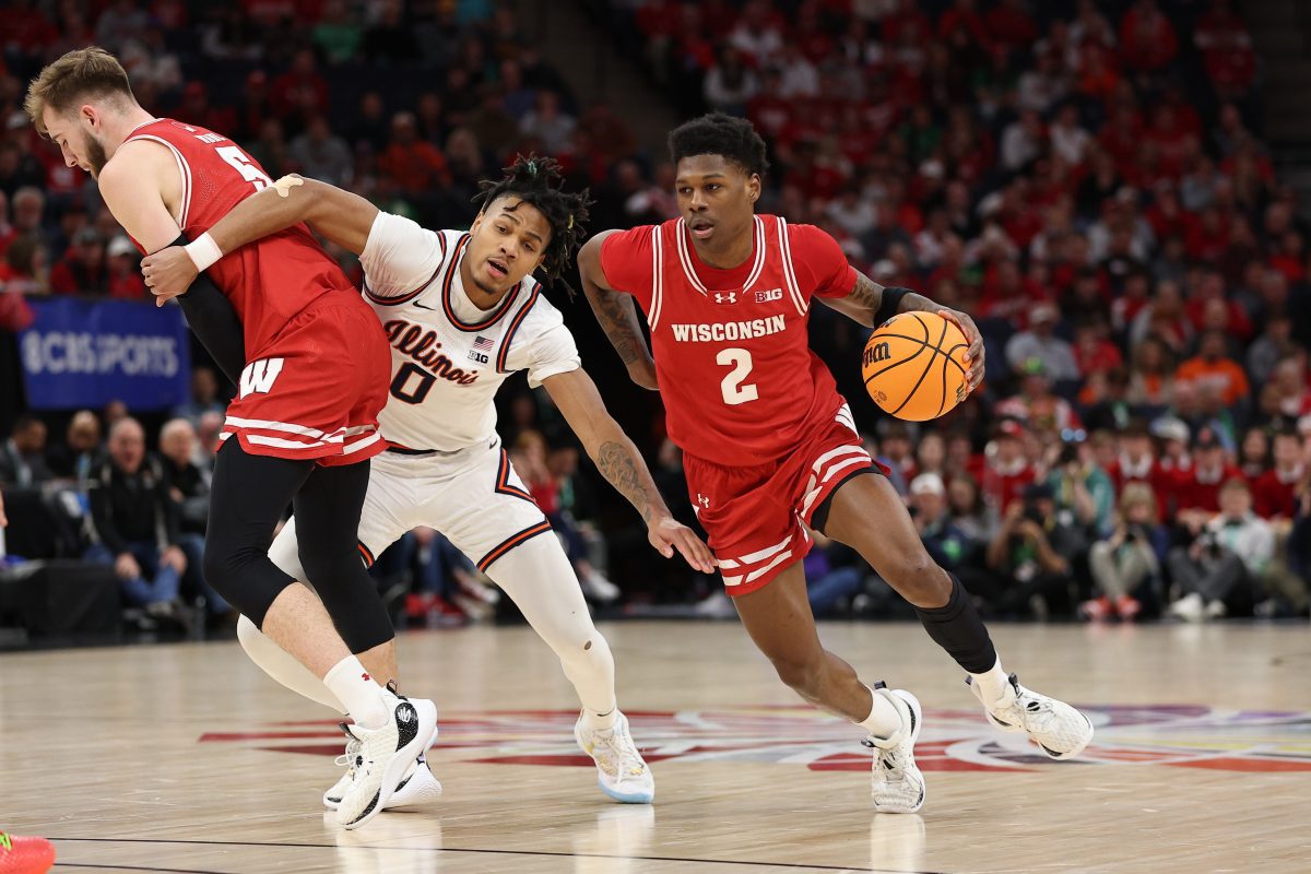 Mar 17, 2024; Minneapolis, MN, USA; Wisconsin Badgers guard AJ Storr (2) dribbles the ball in the first half pressured by Illinois Fighting Illini guard Terrence Shannon Jr. (0) in the first half at Target Center. Mandatory Credit: Matt Krohn-USA TODAY Sports