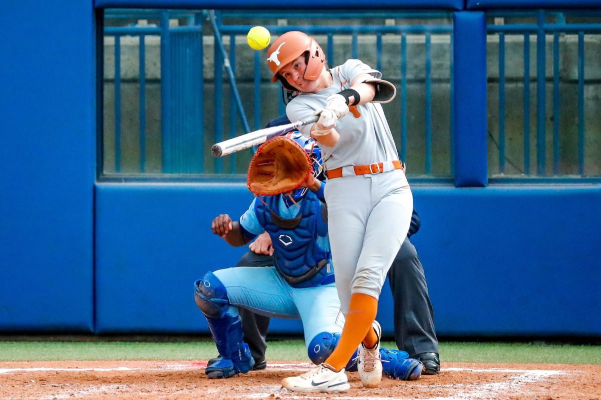 Texas utility Reese Atwood (14) hits a double during the Big 12 softball tournament game between the Texas Longhorns and the Kansas Blue Jays at USA Softball Hall of Fame Stadium in Oklahoma City, on Friday, May 12, 2023.