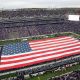 Nov 11, 2023; Manhattan, Kansas, USA; The American flag covers the field before the start of a game between the Baylor Bears and the Kansas State Wildcats at Bill Snyder Family Football Stadium. Mandatory Credit: Scott Sewell-USA TODAY Sports
