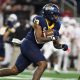 Dec 2, 2023; Detroit, MI, USA; Toledo Rockets running back Peny Boone (13) runs the ball against the Miami (OH) Redhawks in the first quarter at Ford Field. Mandatory Credit: Lon Horwedel-USA TODAY Sports