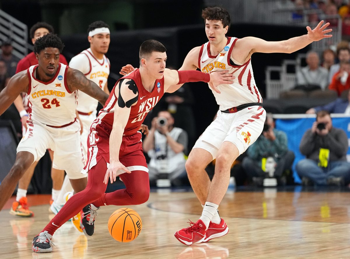 Washington State Cougars forward Andrej Jakimovski (23) drives to the basket as Iowa State Cyclones forward Milan Momcilovic (22) defends in a second-round NCAA Tournament game between Iowa State and Washington State, Saturday, March 23, 2024 at CHI Health Center Arena in Omaha.
