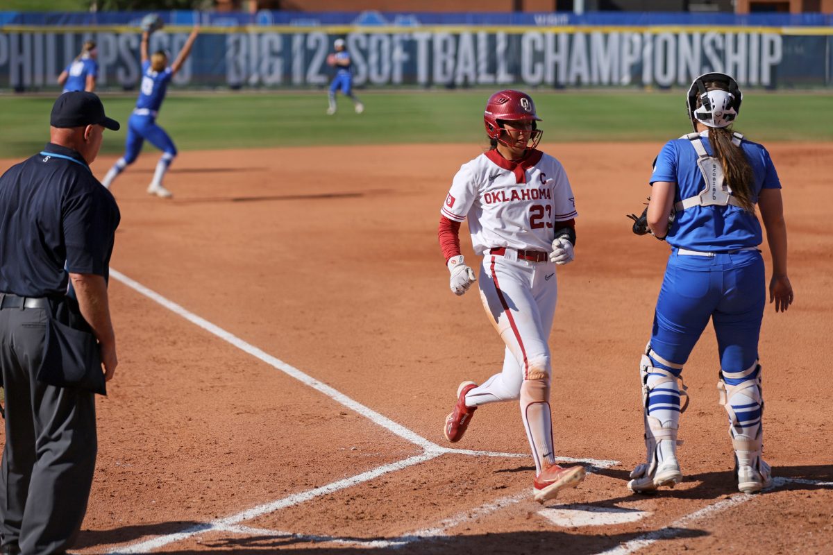 Oklahoma second baseman Tiare Jennings (23) scores a run in the first inning of a Big 12 softball tournament game between the University of Oklahoma Sooners (OU) and the BYU Cougars at Devon Park in Oklahoma City, Friday, May 10, 2024. Oklahoma won 13-2.