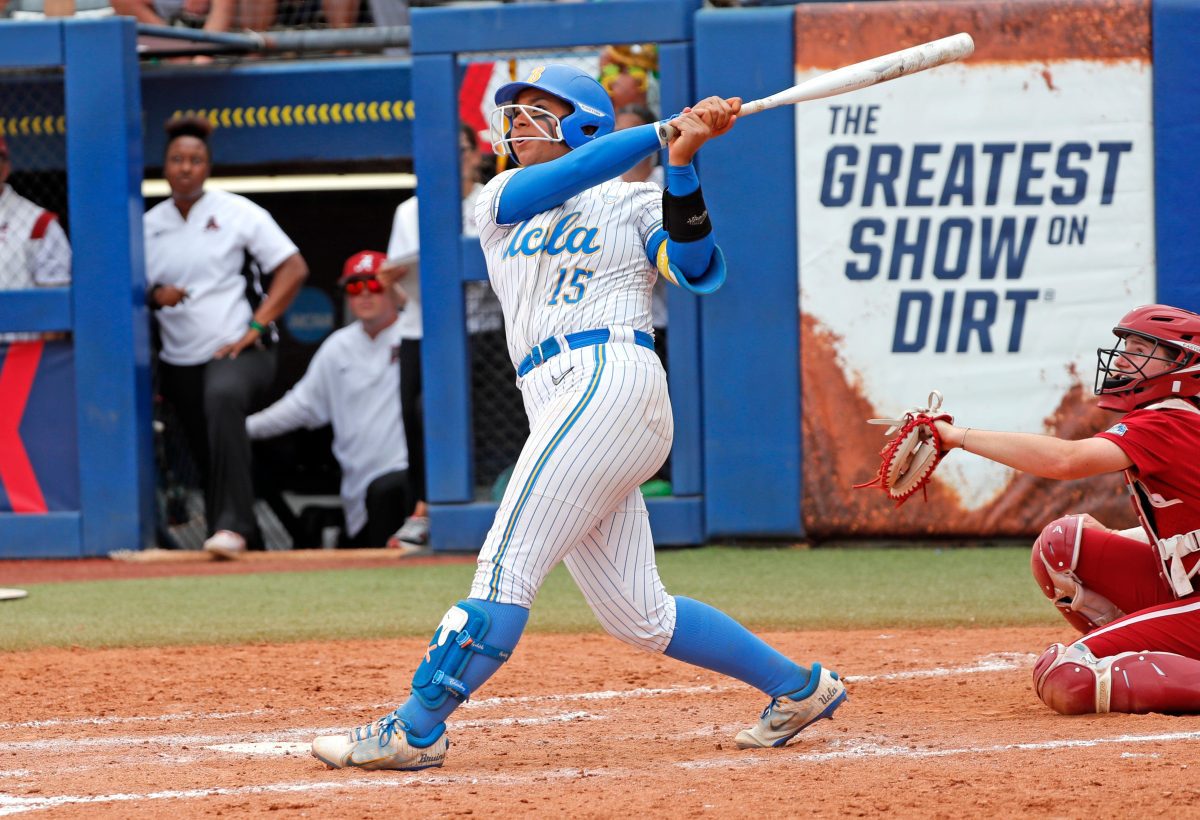 UCLA's Jordan Woolery (15) hits a home run in the sixth inning of the Women's College World Series game between Alabama and UCLA at Devon Park in Oklahoma City, Thursday, May, 30, 2024.