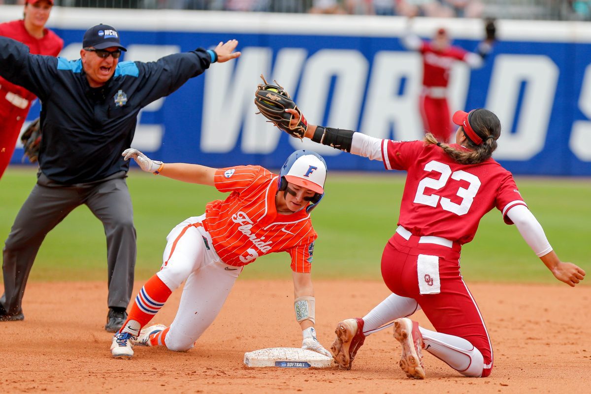 Florida outfielder Korbe Otis (33) slides into second base safe as Oklahoma second baseman Tiare Jennings (23) attempts to tag out during a Women’s College World Series semifinal game between Oklahoma (OU) and Florida at Devon Park in Oklahoma City, on Monday, June 3, 2024.