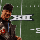 WWE Legend The Undertaker holding a Big 12 Championship Title Belt.