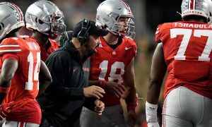 Sep 7, 2024; Columbus, Ohio, USA; Ohio State Buckeyes head coach Ryan Day talks to quarterback Will Howard (18) in the huddle during the second half of the NCAA football game against the Western Michigan Broncos at Ohio Stadium.