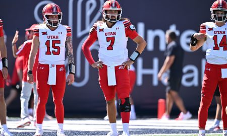 Sep 14, 2024; Logan, Utah, USA; Utah Utes quarterback Cameron Rising (7) watches as his teammates warm up before a game against the Utah State Aggies at Merlin Olsen Field at Maverik Stadium. Mandatory Credit: Jamie Sabau-Imagn Images