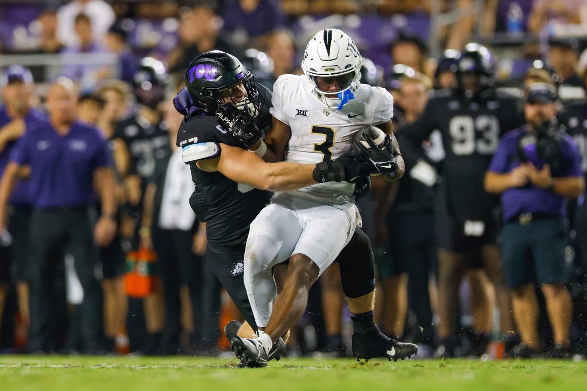 Sep 14, 2024; Fort Worth, Texas, USA; UCF Knights wide receiver Xavier Townsend (3) is tackled by TCU Horned Frogs linebacker Johnny Hodges (57) during the third quarter at Amon G. Carter Stadium. Mandatory Credit: Andrew Dieb-Imagn Images