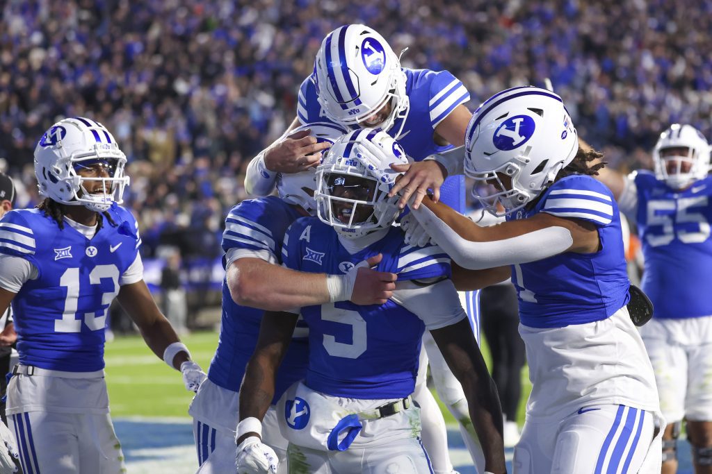 Oct 18, 2024; Provo, Utah, USA; Brigham Young Cougars wide receiver Darius Lassiter (5) celebrates a touchdown with teammates in the last minute of the game against the Oklahoma State Cowboys at LaVell Edwards Stadium. Mandatory Credit: Rob Gray-Imagn Images