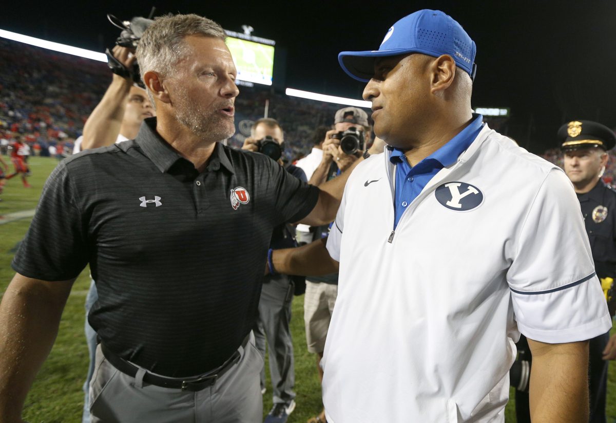 Sep 9, 2017; Provo, UT, USA; Utah Utes head coach Kyle Whittingham (left) and Brigham Young Cougars head coach Kalani Sitake (right) greet each other after Utah defeated BYU at LaVell Edwards Stadium. Mandatory Credit: George Frey-USA TODAY Sports