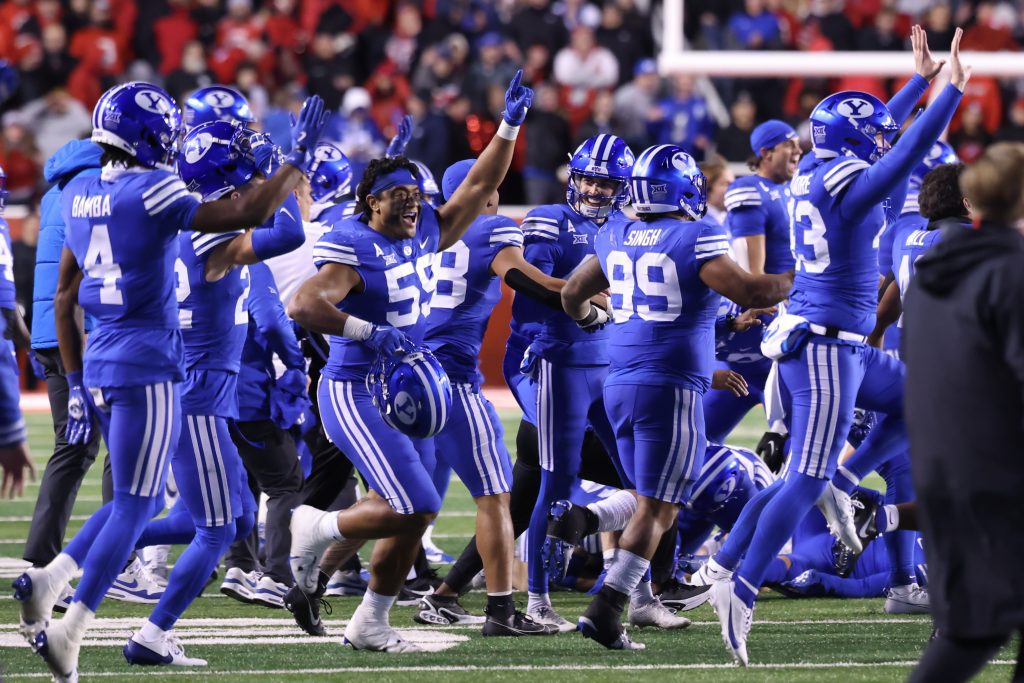 Nov 9, 2024; Salt Lake City, Utah, USA; The Brigham Young Cougars run on the field after defeating the Utah Utes at Rice-Eccles Stadium. Mandatory Credit: Rob Gray-Imagn Images