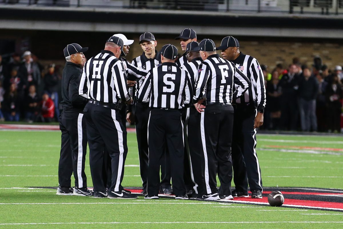 Nov 9, 2024; Lubbock, Texas, USA; The Big 12 officiating crew meet at mid-field in the second half during the game between the Texas Tech Red Raiders and the Colorado Buffalos at Jones AT&T Stadium and Cody Campbell Field. Mandatory Credit: Michael C. Johnson-Imagn Images