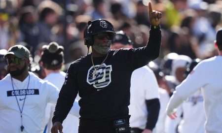Nov 16, 2024; Boulder, Colorado, USA; Colorado Buffaloes head coach Deion Sanders calls in a play in the first quarter against the Utah Utes at Folsom Field. Mandatory Credit: Ron Chenoy-Imagn Images