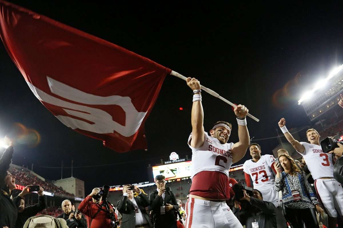 Oklahoma Sooners quarterback Baker Mayfield (6) waves the school flag following their 31-16 win over the Ohio State Buckeyes during NCAA football game at Ohio Stadium in Columbus on Sept. 9, 2017. [Adam Cairns/Dispatch]