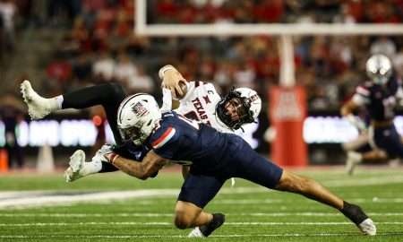 Oct 5, 2024; Tucson, Arizona, USA; Arizona Wildcats defensive back Dalton Johnson (43) tackles Texas Tech Red Raiders quarterback Behren Morton (2) during third quarter at Arizona Stadium. Mandatory Credit: Aryanna Frank-Imagn Images
