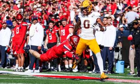 Nov 30, 2024; Tucson, Arizona, USA; Arizona Wildcats Jack Luttrell defensive back Jack Luttrell (13) tackles Arizona State Sun Devils wide receiver Jordyn Tyson (0) during the first half at Arizona Stadium. Mandatory Credit: Aryanna Frank-Imagn Images