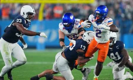 Dec 31, 2024; Glendale, AZ, USA; Boise State Broncos running back Ashton Jeanty (2) rushes the ball against Penn State Nittany Lions linebacker Tony Rojas (13) during the first half in the Fiesta Bowl at State Farm Stadium. Mandatory Credit: Joe Camporeale-Imagn Images