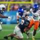 Dec 31, 2024; Glendale, AZ, USA; Boise State Broncos running back Ashton Jeanty (2) rushes the ball against Penn State Nittany Lions linebacker Tony Rojas (13) during the first half in the Fiesta Bowl at State Farm Stadium. Mandatory Credit: Joe Camporeale-Imagn Images