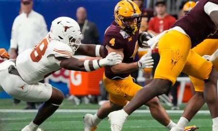 Arizona State running back Cam Skattebo (4) is tackled by Texas linebacker Barryn Sorrell (88) during the first quarter of the Chick-fil-A Peach Bowl in Atlanta on Wednesday, Jan. 1, 2025.
