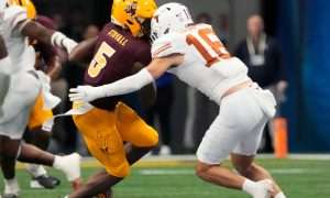 Arizona State wide receiver Melquan Stovall (5) is tackled by Texas defensive back Michael Taaffe (16) after a catch during the fourth quarter in the Chick-fil-A Peach Bowl. The play was reviewed for targetting but was not called.