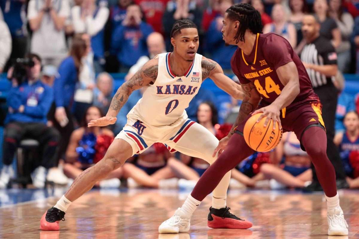 Arizona State Sun Devils guard Adam Miller (44) defends the ball from Kansas Jayhawks guard Shakeel Moore (0) in the first half of the game inside Allen Fieldhouse Wednesday, Jan. 8, 2025.