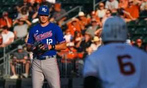 Kansas pitcher Dominic Voegele (12) watches Texas Longhorns catcher Rylan Galvan (6) before throwing a pitch during the game at UFCU Disch–Falk Field on Friday, May. 17, 2024 in Austin.