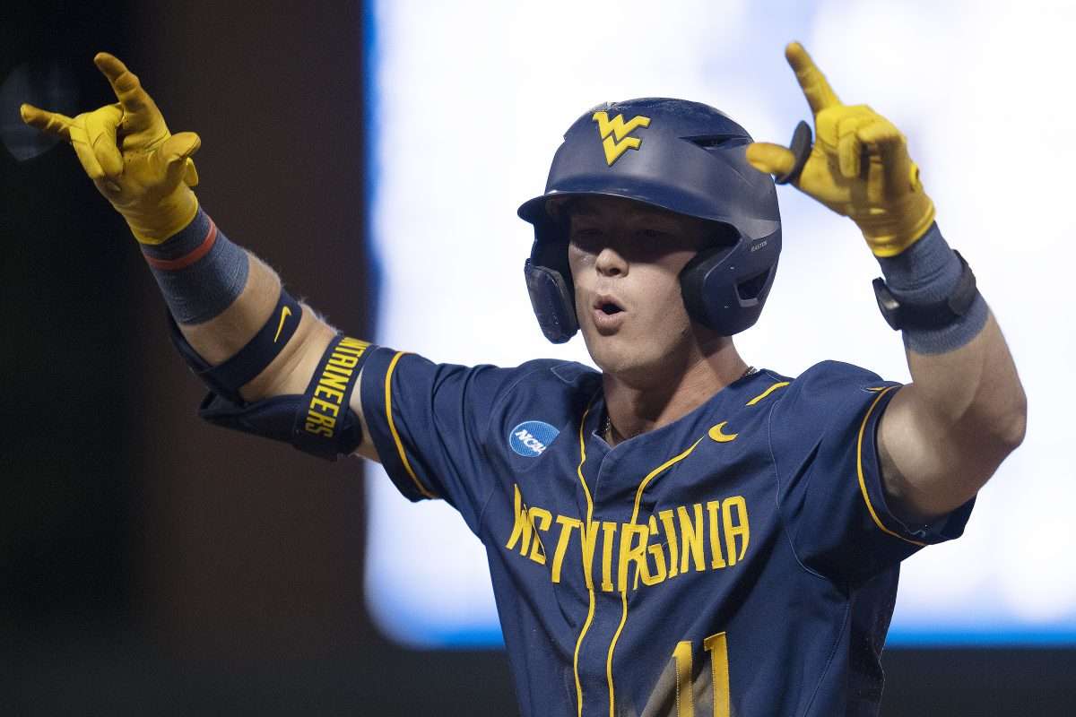 Jun 8, 2024; Chapel Hill, NC, USA; West Virginia Mountaineers Sam White (11) reacts to getting on base against the North Carolina Tar Heels in the ninth inning of the DI Baseball Super Regional at Boshamer Stadium. Mandatory Credit: Jeffrey Camarati-USA TODAY Sports