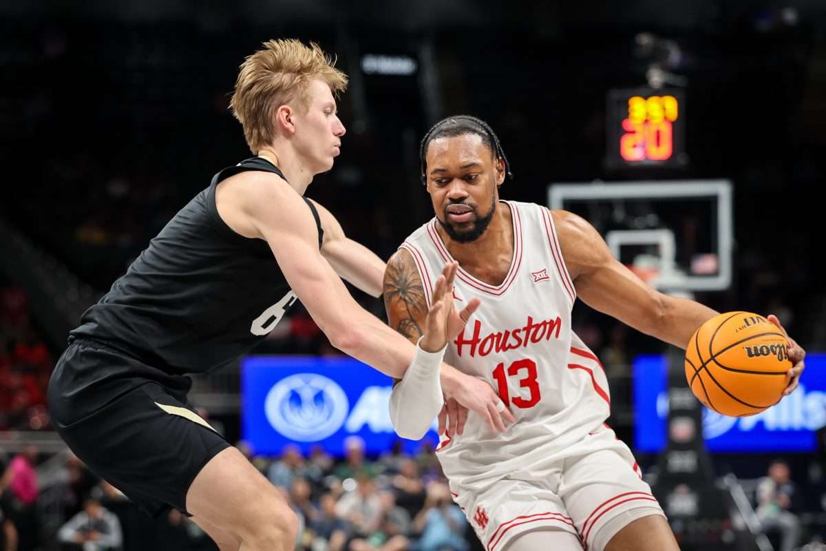 Mar 13, 2025; Kansas City, MO, USA; Houston Cougars forward J'Wan Roberts (13) drives to the basket around Colorado Buffaloes forward Trevor Baskin (6) during the first half at T-Mobile Center. Mandatory Credit: William Purnell-Imagn Images