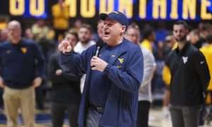 Feb 19, 2025; Morgantown, West Virginia, USA; West Virginia Mountaineers head football coach Rich Rodriguez speaks to the crowd during a timeout during the first half against the Cincinnati Bearcats at WVU Coliseum. Mandatory Credit: Ben Queen-Imagn Images