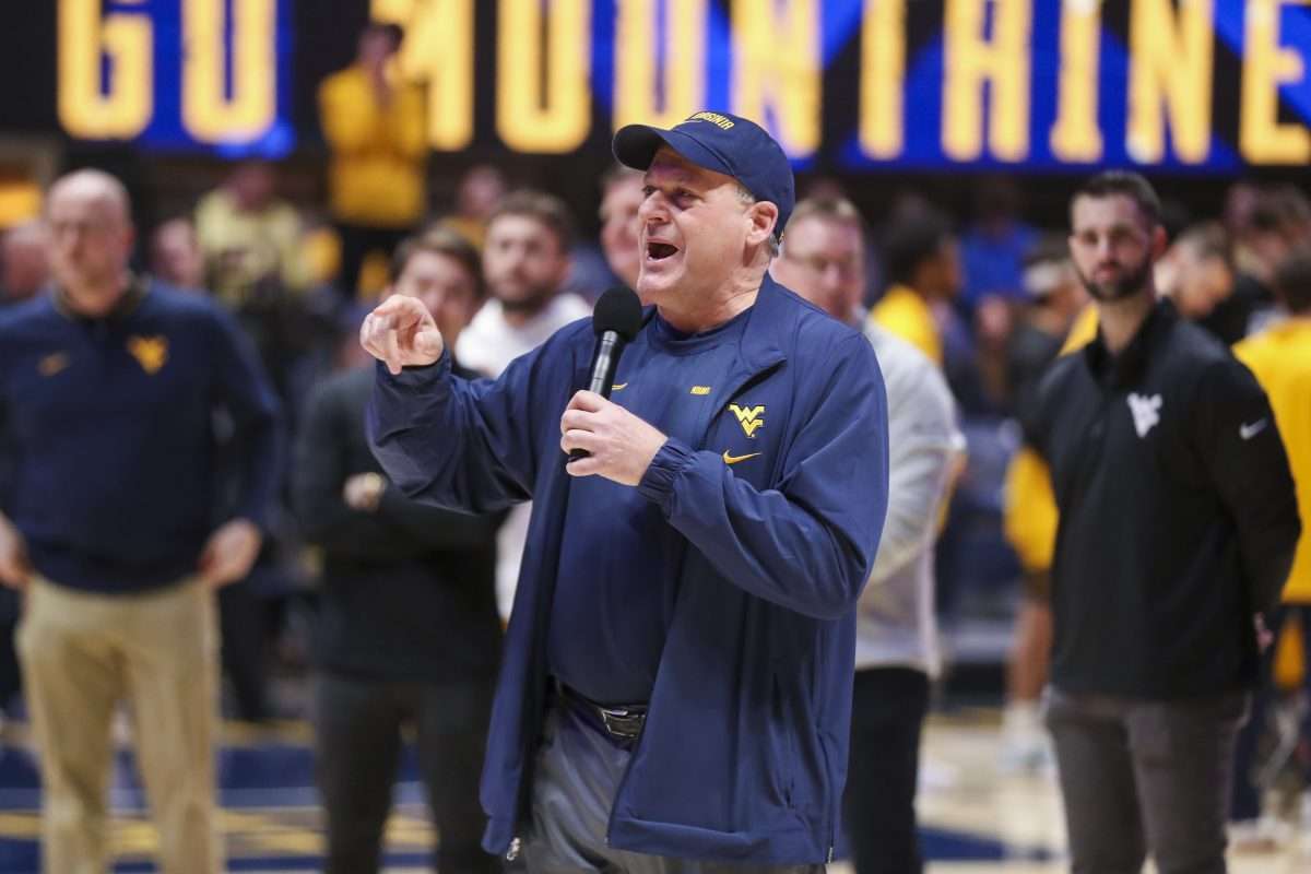 Feb 19, 2025; Morgantown, West Virginia, USA; West Virginia Mountaineers head football coach Rich Rodriguez speaks to the crowd during a timeout during the first half against the Cincinnati Bearcats at WVU Coliseum. Mandatory Credit: Ben Queen-Imagn Images