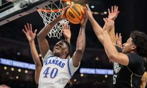 Mar 12, 2025; Kansas City, MO, USA; Kansas Jayhawks forward Flory Bidunga (40) shoots the ball during the first half against the UCF Knights at T-Mobile Center. Mandatory Credit: William Purnell-Imagn Images